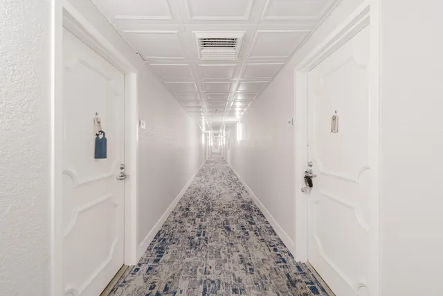 a view of a hallway view with wooden floor and staircase