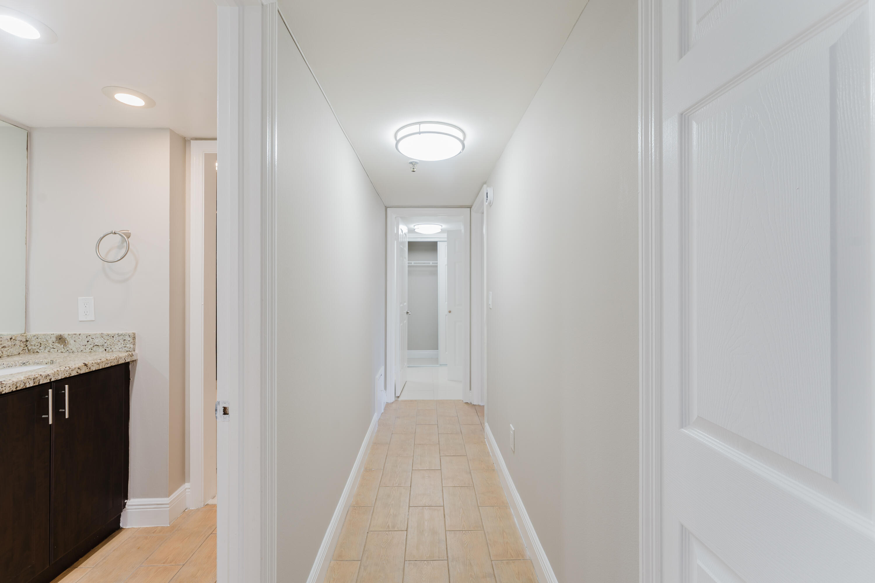 859 Jeffery Street, Unit 208 Boca Raton, FL 33487 - Photo 17 of 39 a view of a hallway with wooden floor