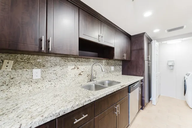 a kitchen with sink cabinets and microwave