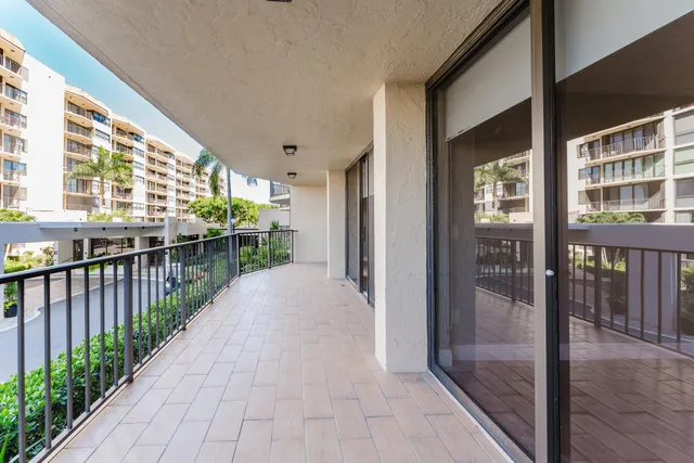 a bathroom with a granite countertop sink a large mirror and a bathtub