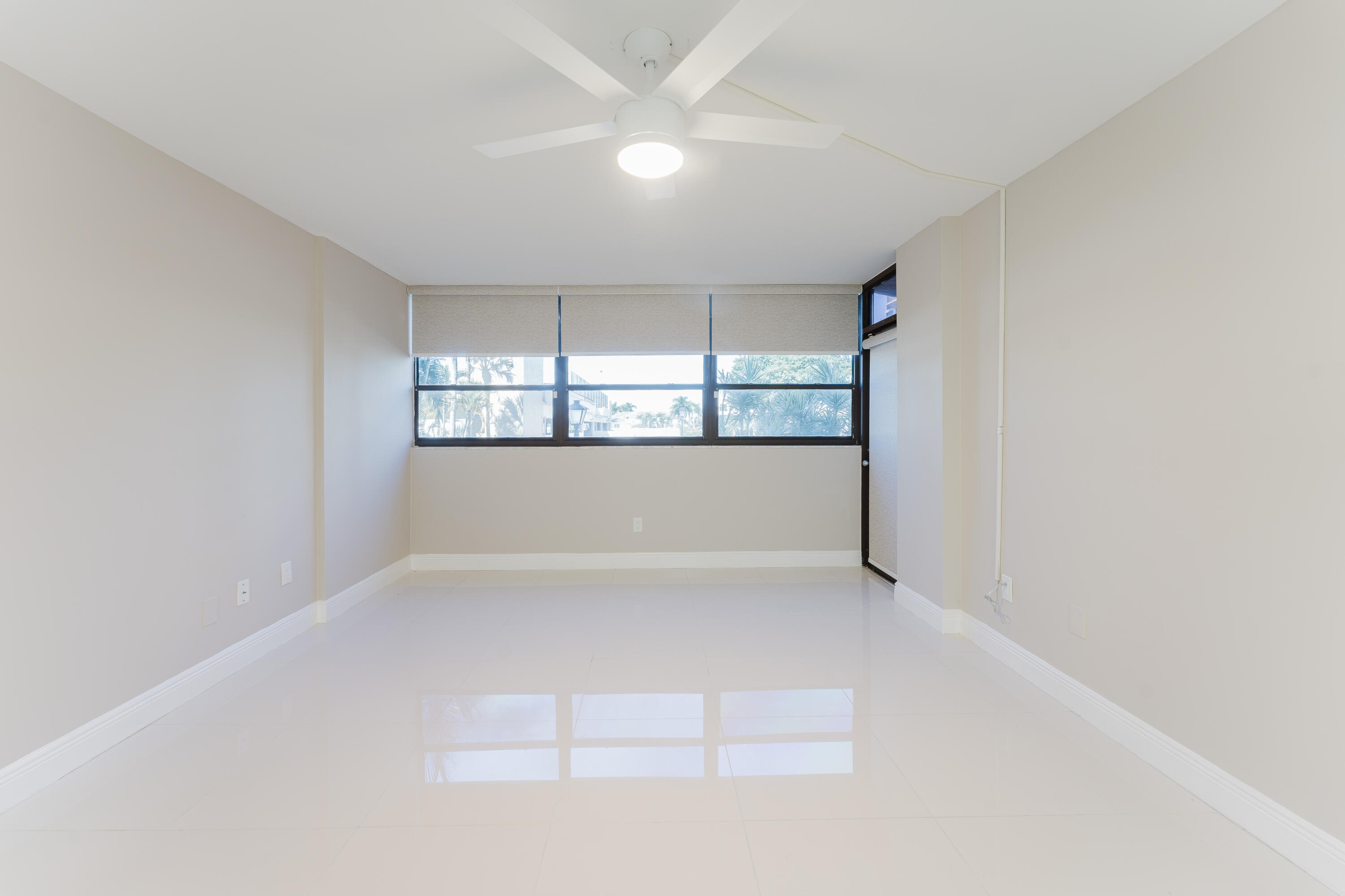859 Jeffery Street, Unit 208 Boca Raton, FL 33487 - Photo 33 of 39 an empty room with a windows and ceiling fan