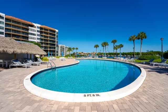 a view of a swimming pool with outdoor seating