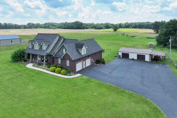 an aerial view of a house with garden and lake view