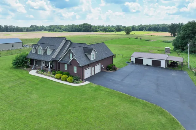 an aerial view of a house with garden and lake view