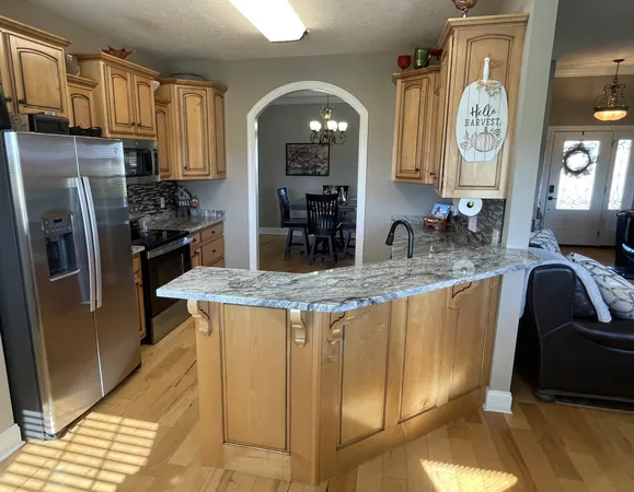 a kitchen with stainless steel appliances granite countertop a stove a sink a refrigerator and dishwasher
