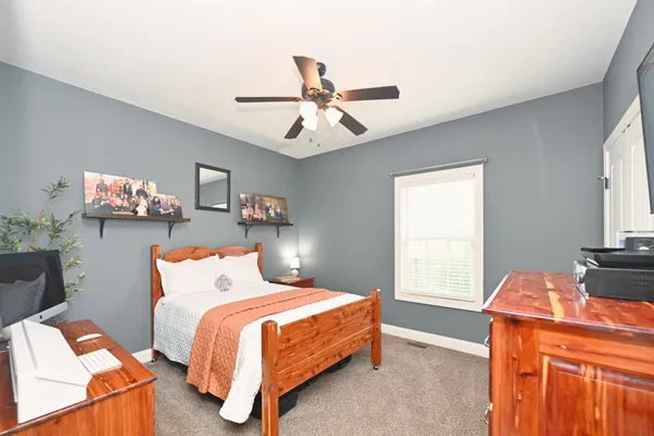 a bedroom with bed and window
