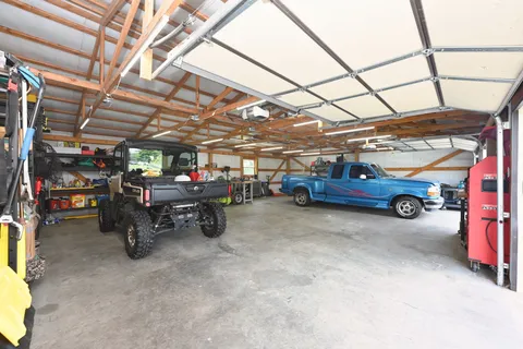 a view of backyard with a small cabin and wooden fence