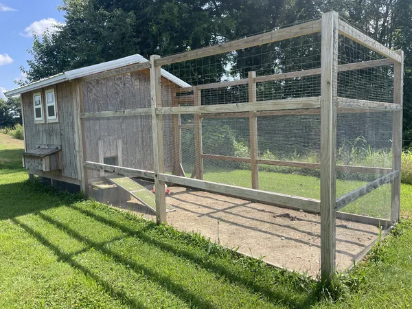 a view of backyard with a small cabin and wooden fence