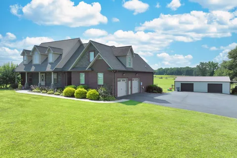 a view of a house with a yard and garage
