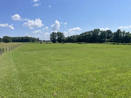 a front view of a house with a garden and yard