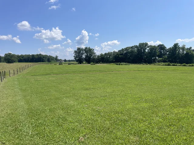a front view of a house with a garden and yard