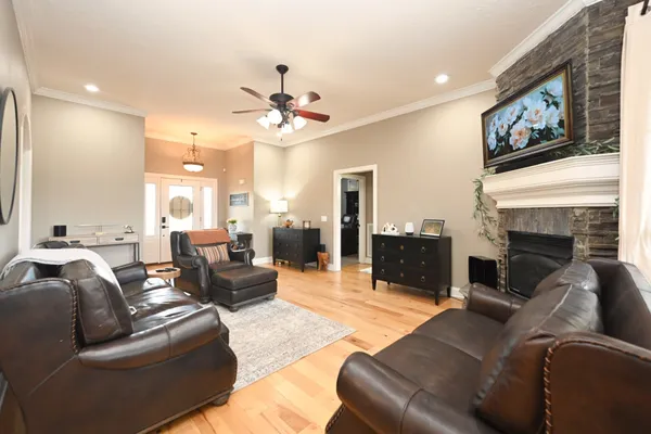 a living room with furniture a fireplace and a flat screen tv