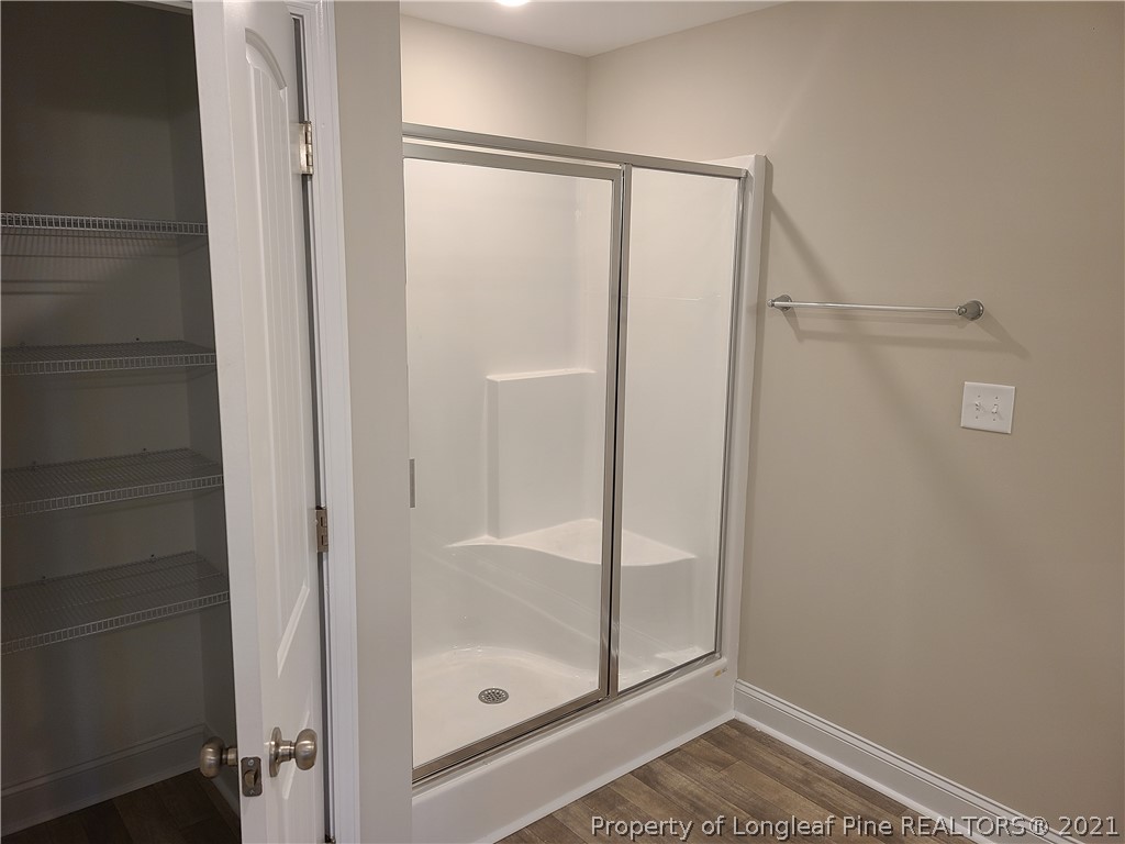 441 Shelton Beard Road Stedman, NC 28391 - Photo 6 of 11 a bathroom with a glass shower door