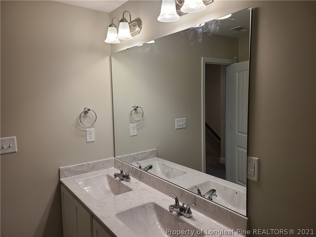 441 Shelton Beard Road Stedman, NC 28391 - Photo 8 of 11 a bathroom with a sink and a mirror