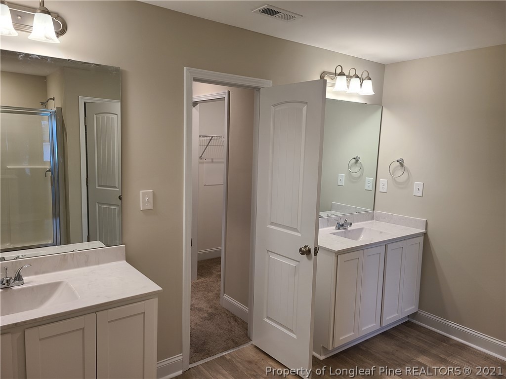 441 Shelton Beard Road Stedman, NC 28391 - Photo 9 of 11 a bathroom with a sink a light fixture and a mirror