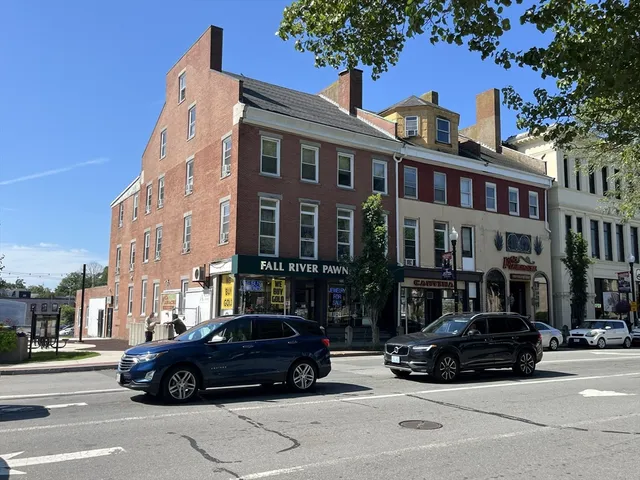 a car parked in front of a tall building