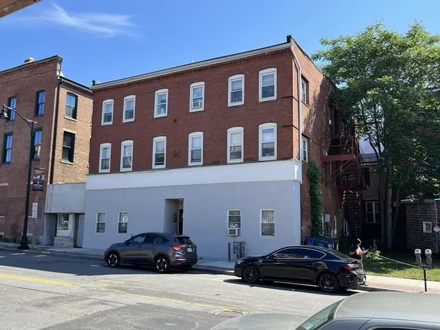 a car parked in front of a brick building