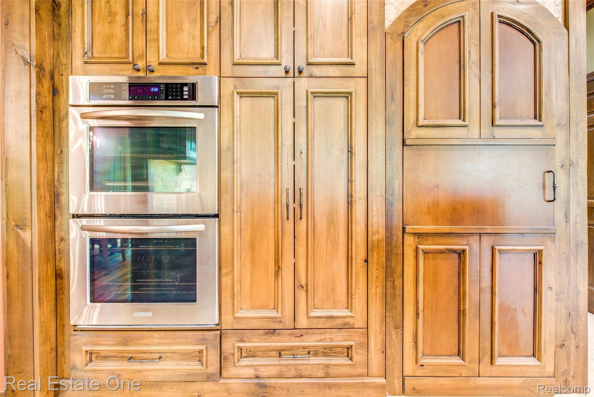 3274 Quail Ridge Circle Rochester, MI 48309 - Photo 25 of 74 Kitchen double wall ovens; top is convection, arched door walk in custom pantry