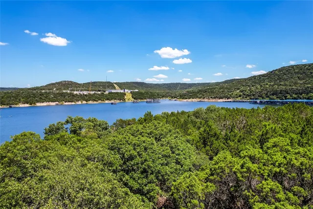 a view of a lake with houses in the back