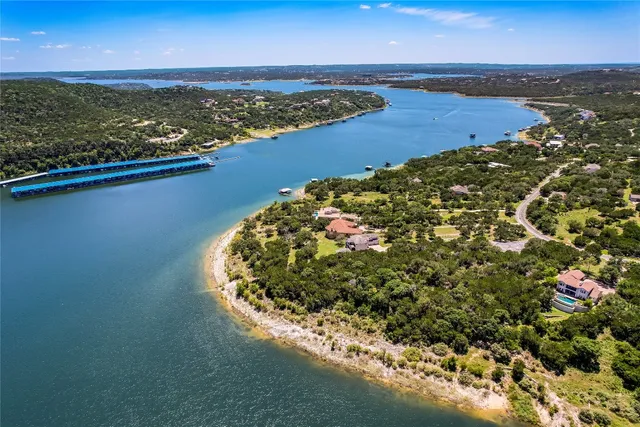 an aerial view of ocean beach and residential houses with outdoor space