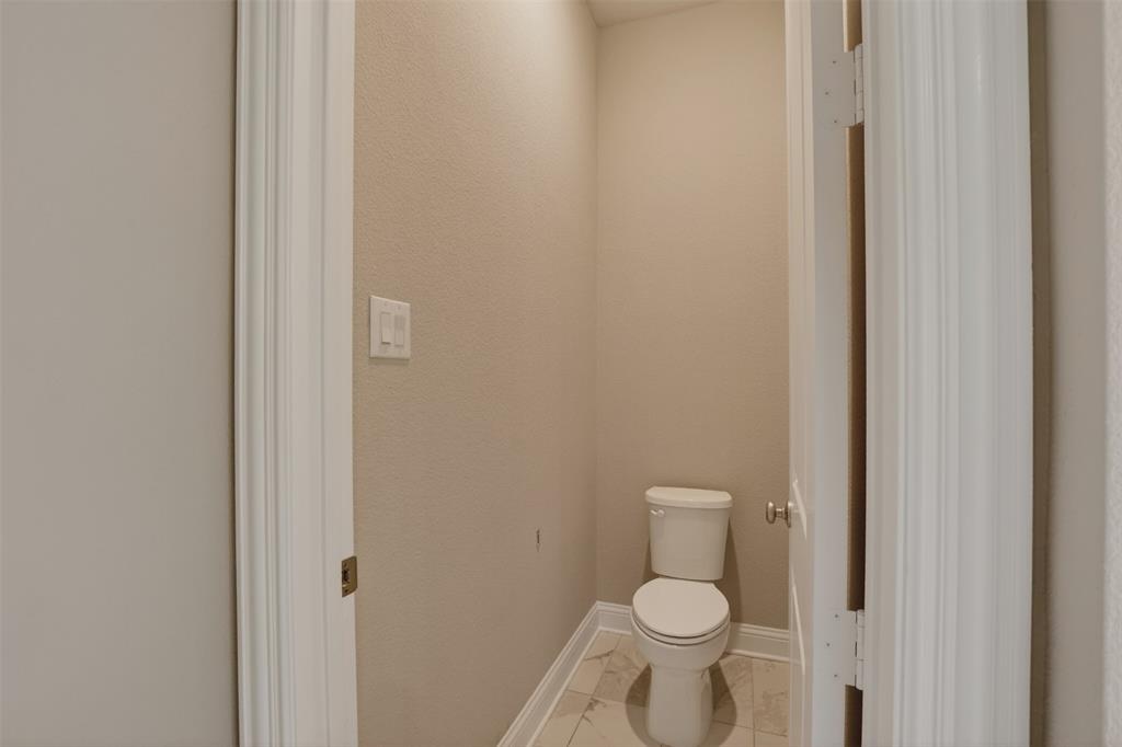 16812 Bitterroot Road Justin, TX 76247 - Photo 23 of 27 a white toilet sitting next to a shower