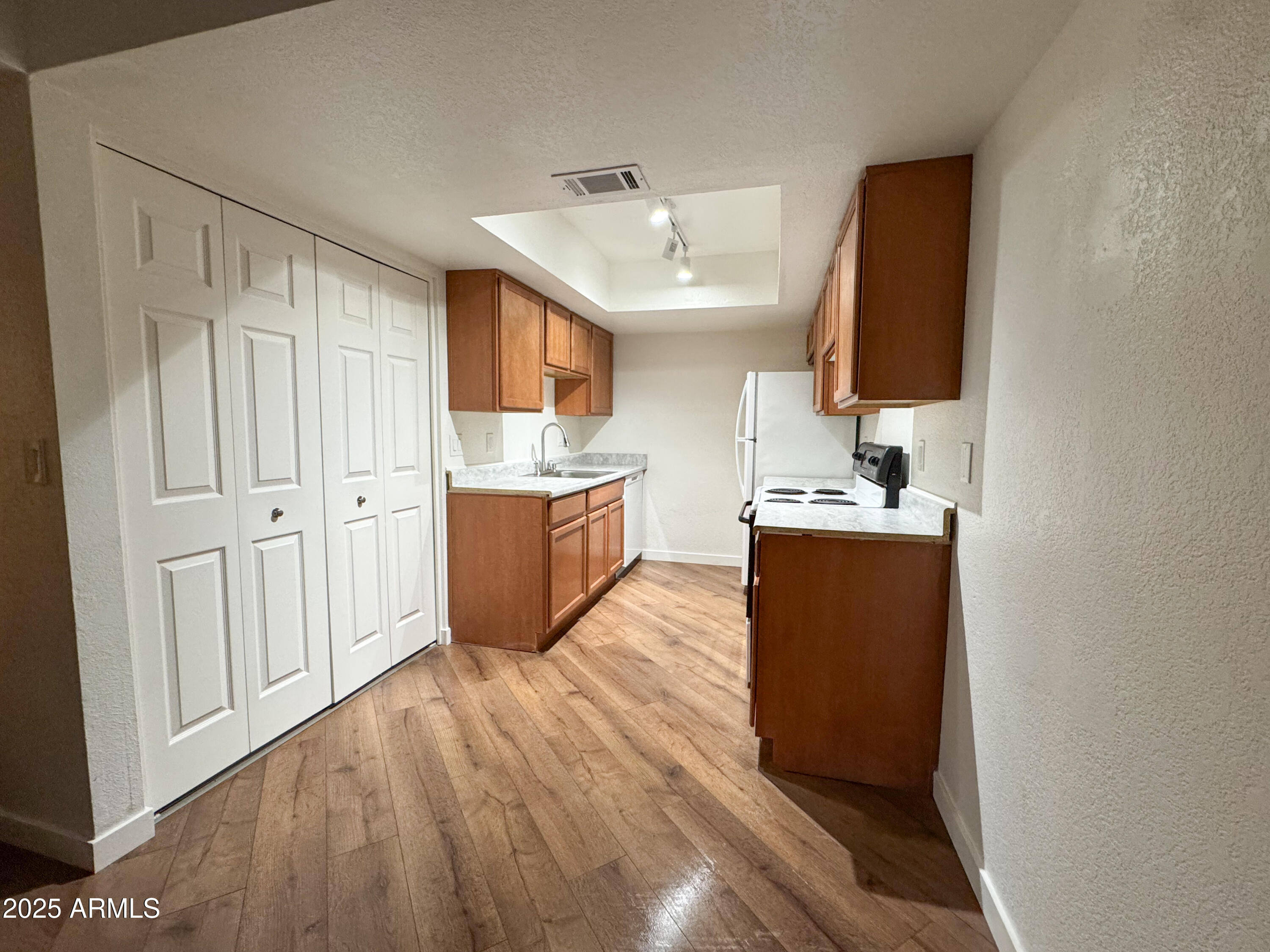 10215 North 8th Avenue, Unit 1 Phoenix, AZ 85021 - Photo 15 of 21 a room with cabinets and wooden floor