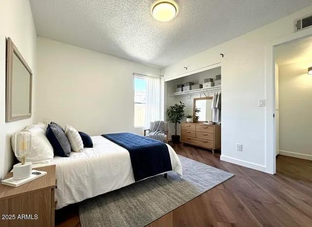 a bedroom with a bed and wooden floor