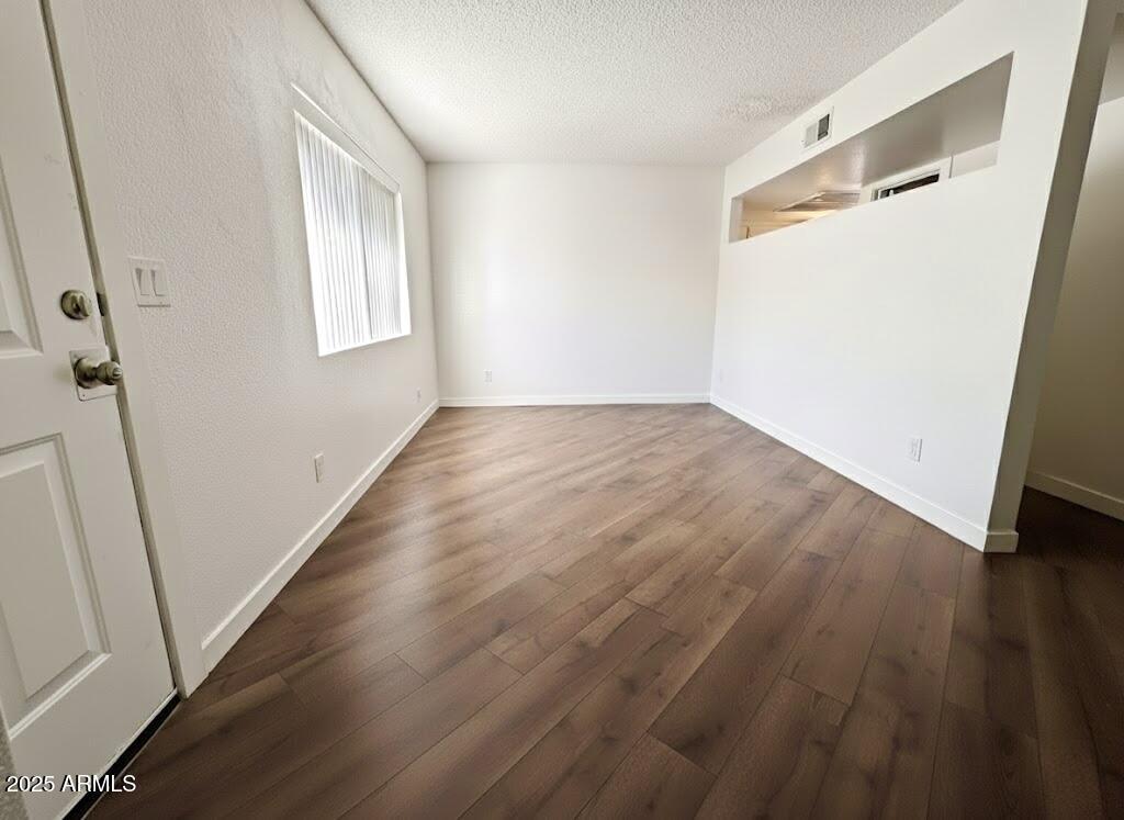 10215 North 8th Avenue, Unit 1 Phoenix, AZ 85021 - Photo 10 of 21 an empty room with wooden floor and windows