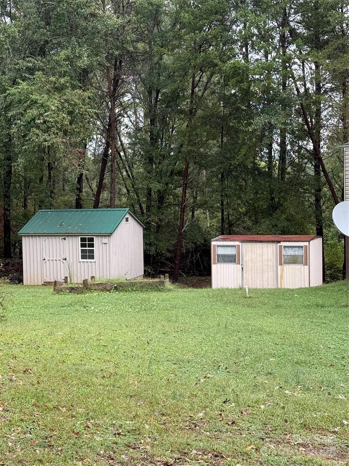 223 Green Acres Road Mooresboro, NC 28114 - Photo 3 of 14 a white house that has a tree in front of it