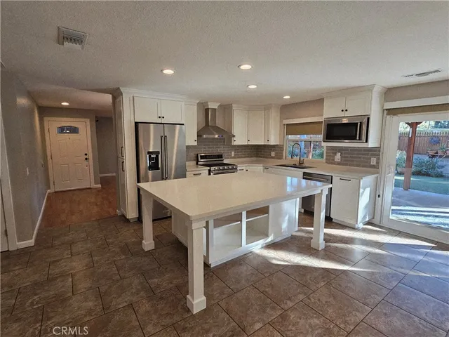 a kitchen with a sink a counter top space a stainless steel appliances and cabinets