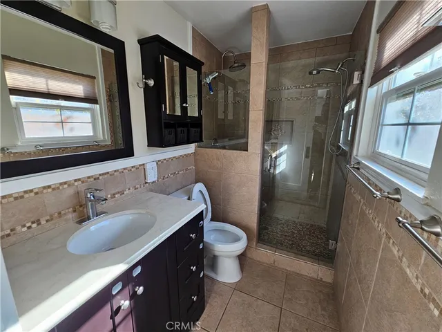 a view of a livingroom with a ceiling fan and window