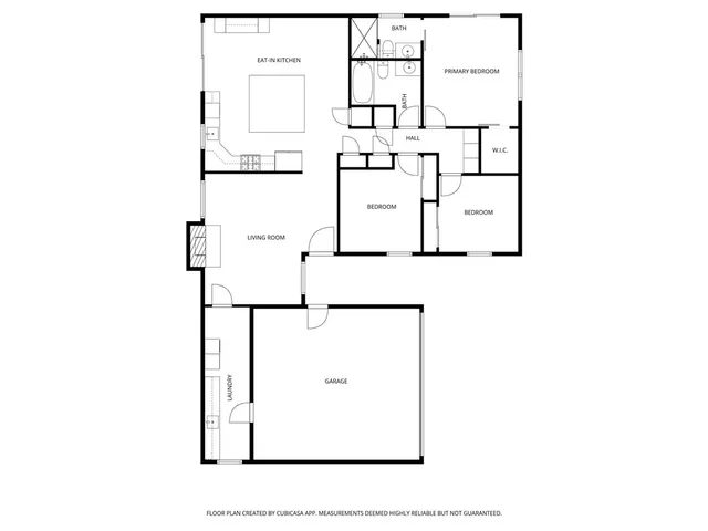 a picture of a bench in front of a wall