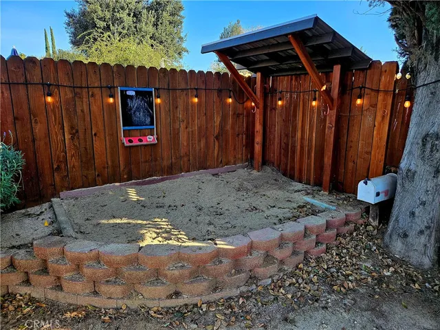 a view of a house with backyard and sitting area