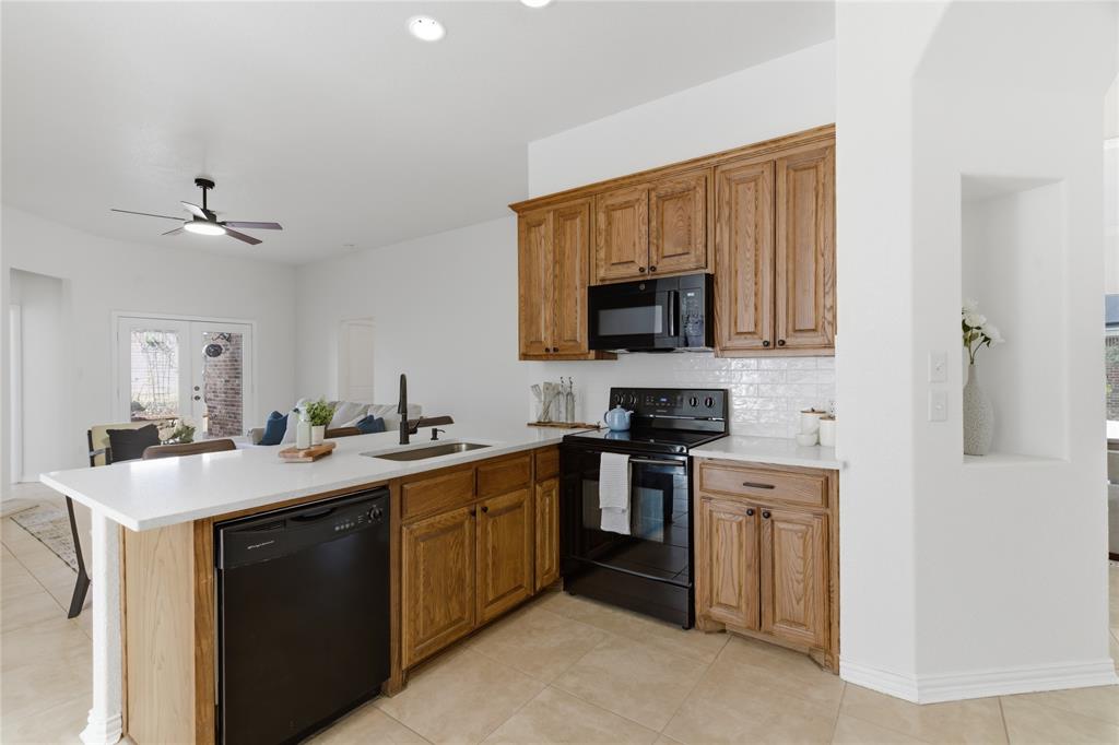 813 Chase Circle Hurst, TX 76053 - Photo 17 of 40 a kitchen with a sink stove and microwave