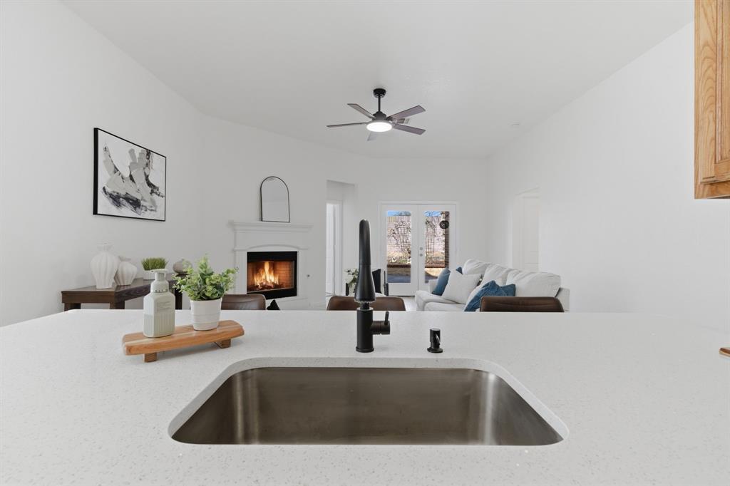 813 Chase Circle Hurst, TX 76053 - Photo 20 of 40 a kitchen with a sink and a fireplace
