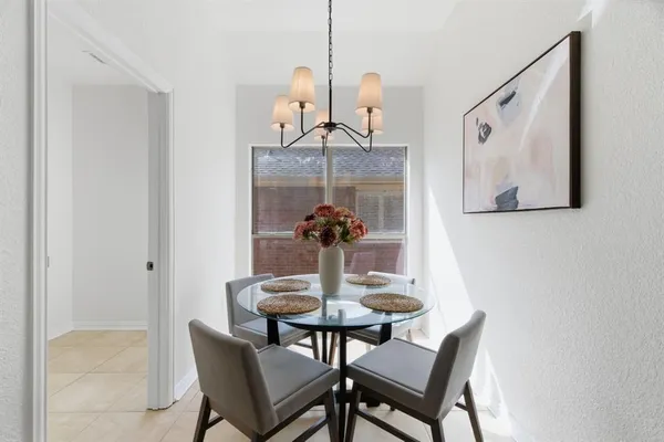 a dining room with a table and chairs