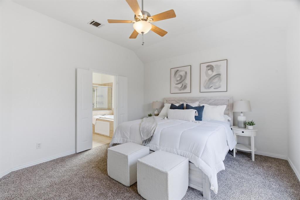 813 Chase Circle Hurst, TX 76053 - Photo 26 of 40 a bedroom with a bed and a chandelier