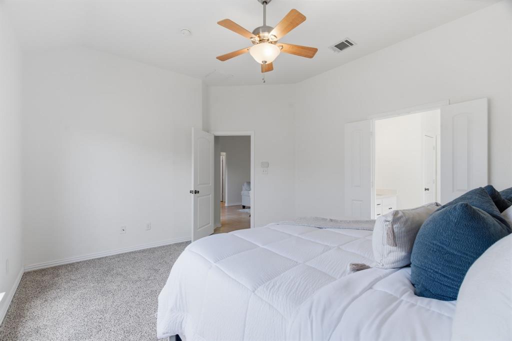 813 Chase Circle Hurst, TX 76053 - Photo 27 of 40 a bedroom with a bed and a ceiling fan