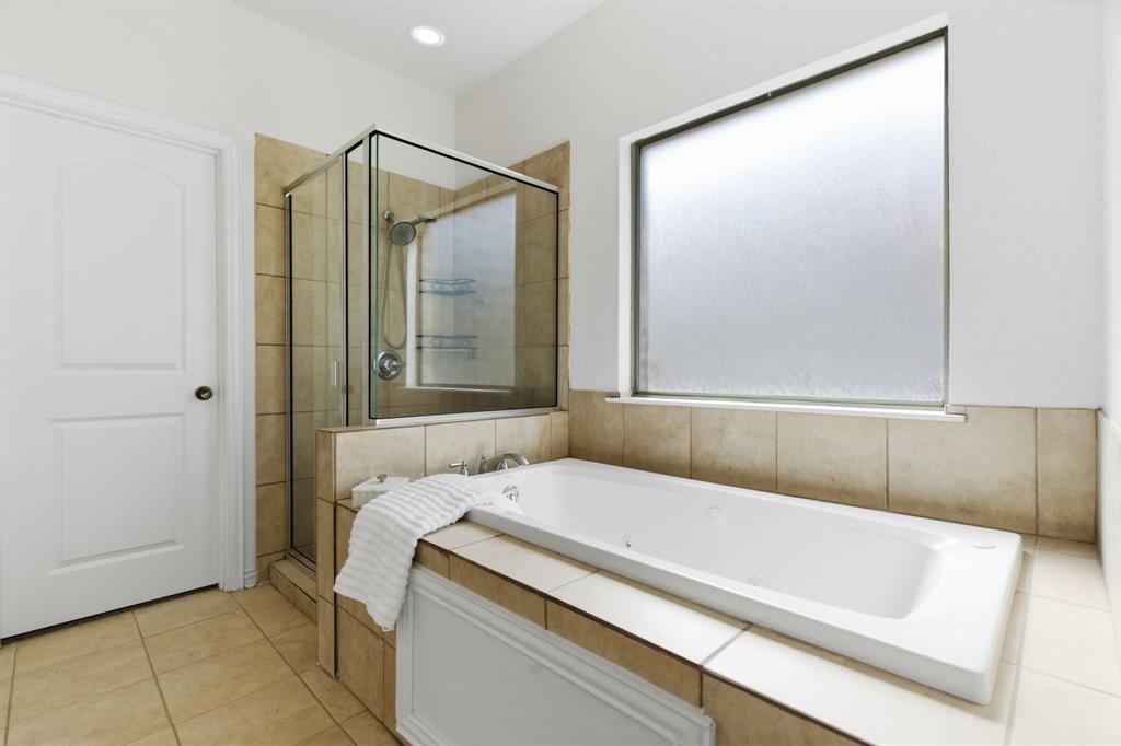 813 Chase Circle Hurst, TX 76053 - Photo 28 of 40 a bathroom with a tub and a shower