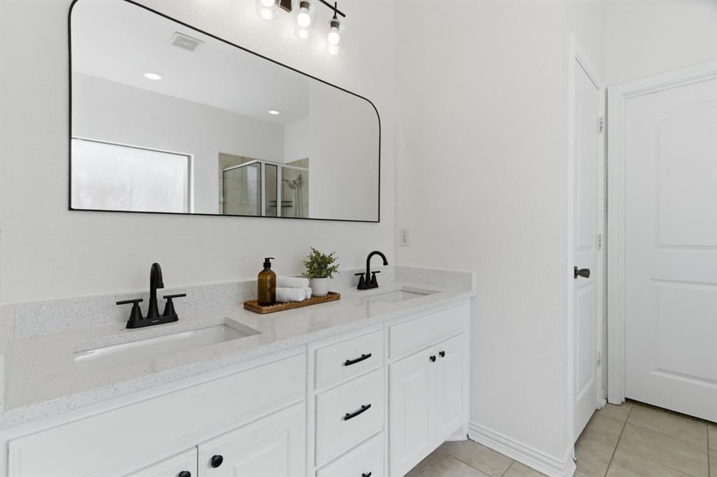 813 Chase Circle Hurst, TX 76053 - Photo 29 of 40 a bathroom with a sink and a mirror