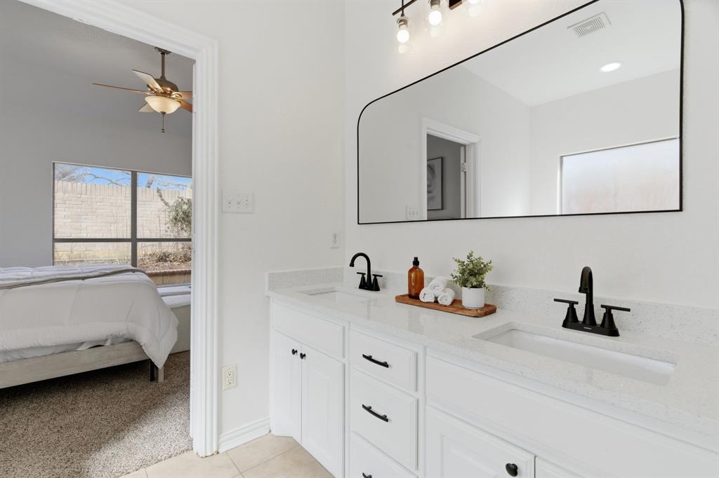 813 Chase Circle Hurst, TX 76053 - Photo 30 of 40 a bathroom with a sink and a mirror