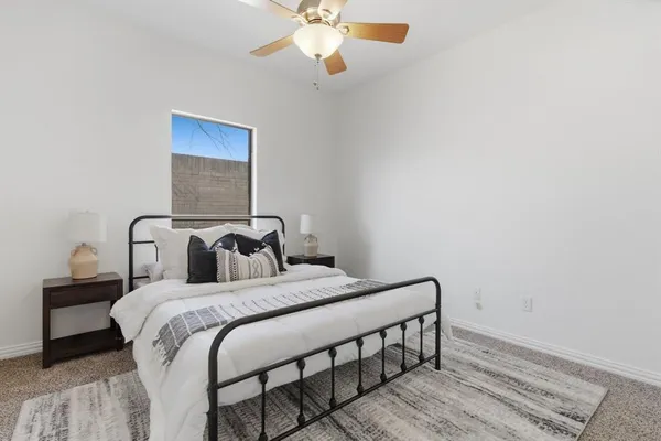 a bedroom with a bed and a chandelier