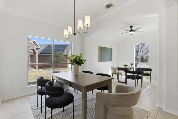 a view of a dining room with furniture a chandelier and wooden floor