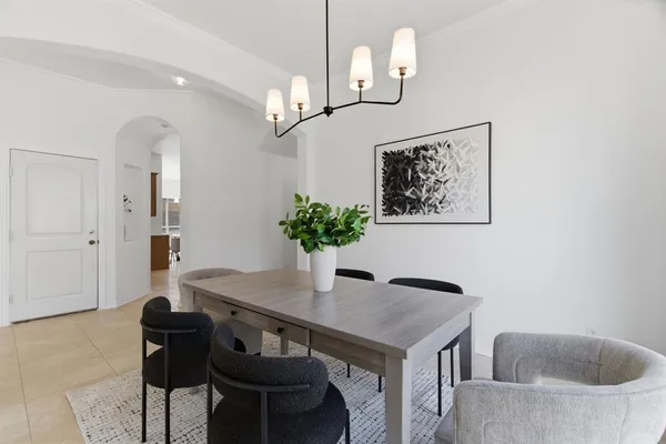 a view of a dining room with furniture and chandelier