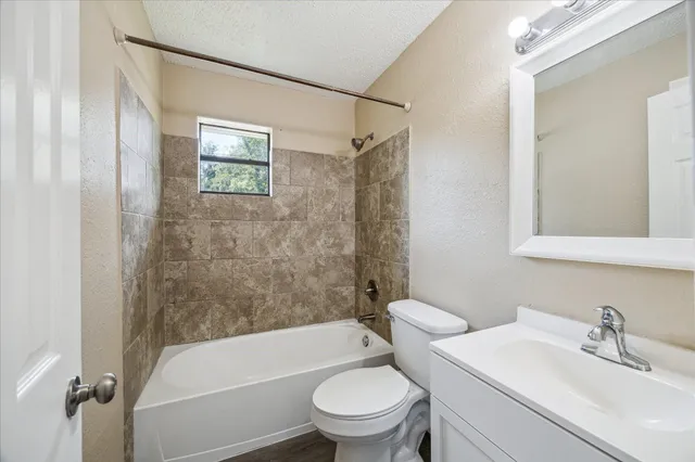 a bathroom with a sink a toilet and a bathtub