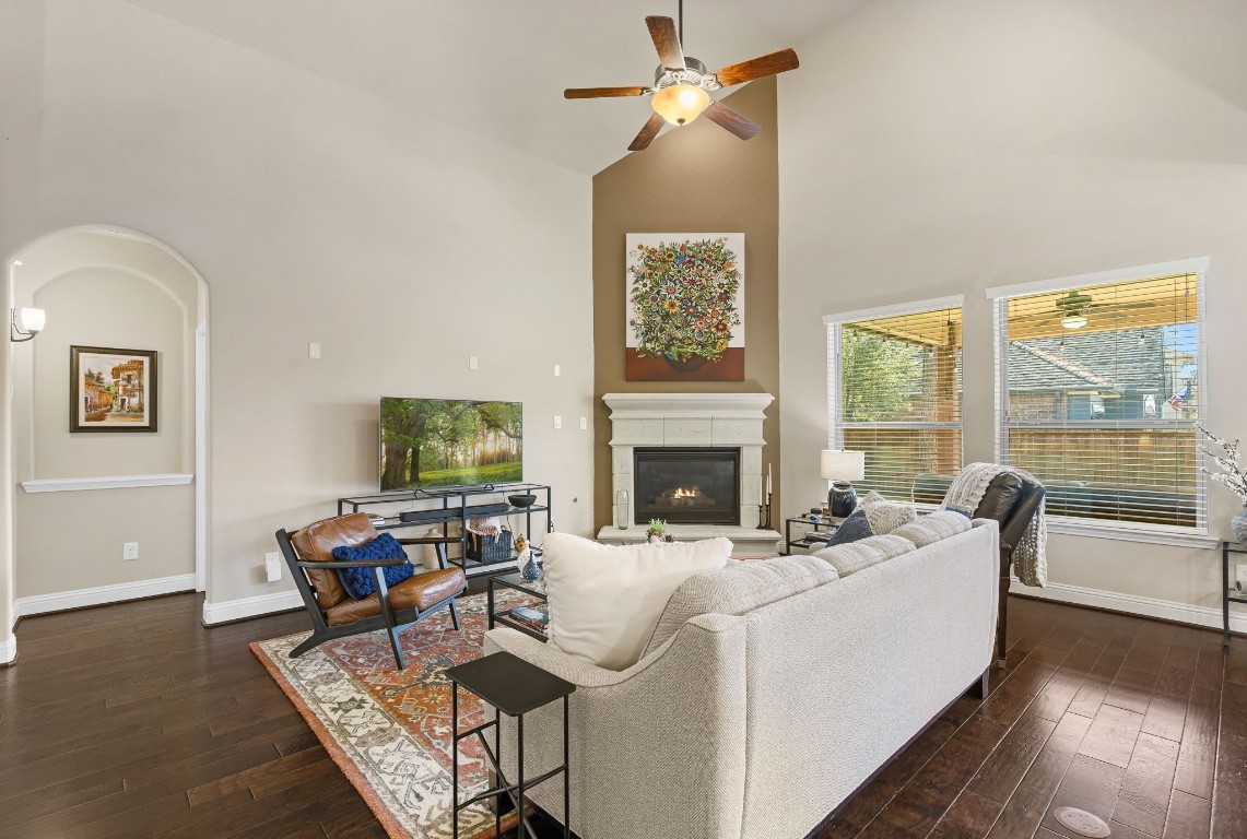 10 Waterfall Way The Woodlands, TX 77375 - Photo 12 of 45 a living room with furniture a flat screen tv and a fireplace