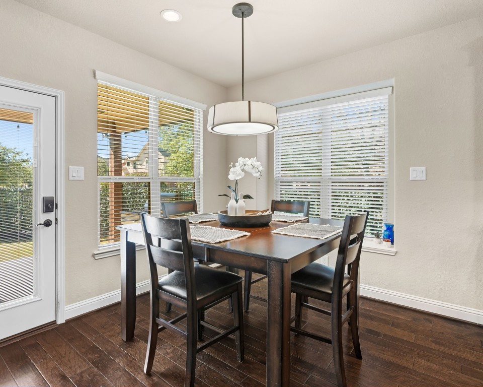 10 Waterfall Way The Woodlands, TX 77375 - Photo 20 of 45 a view of a dining room with furniture window and wooden floor