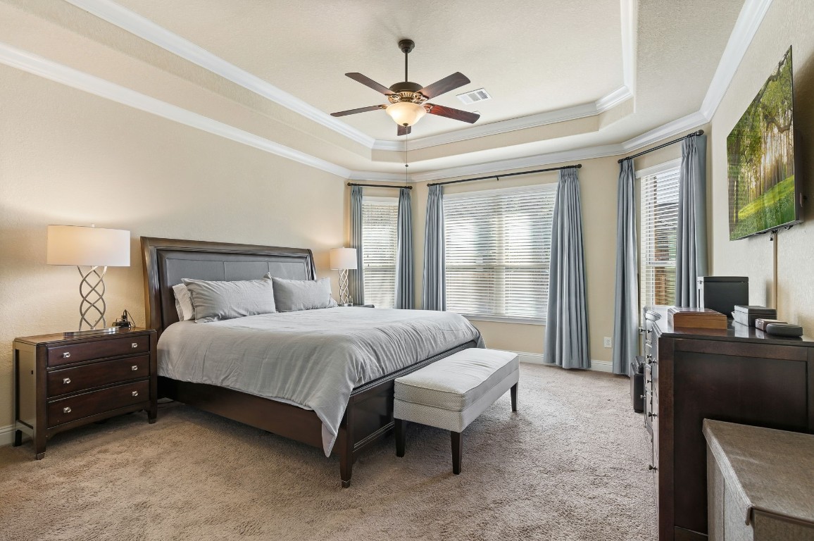 10 Waterfall Way The Woodlands, TX 77375 - Photo 21 of 45 a bedroom with a bed and a large window