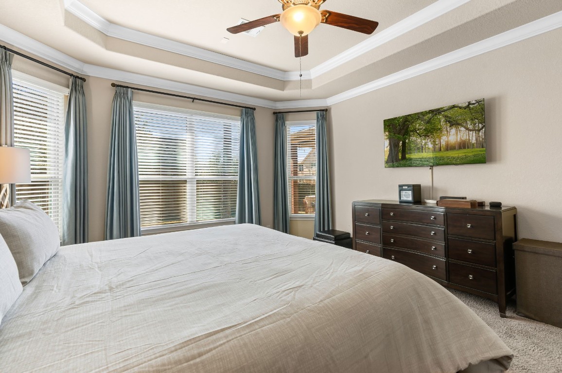 10 Waterfall Way The Woodlands, TX 77375 - Photo 23 of 45 a bedroom with a bed and a flat screen tv