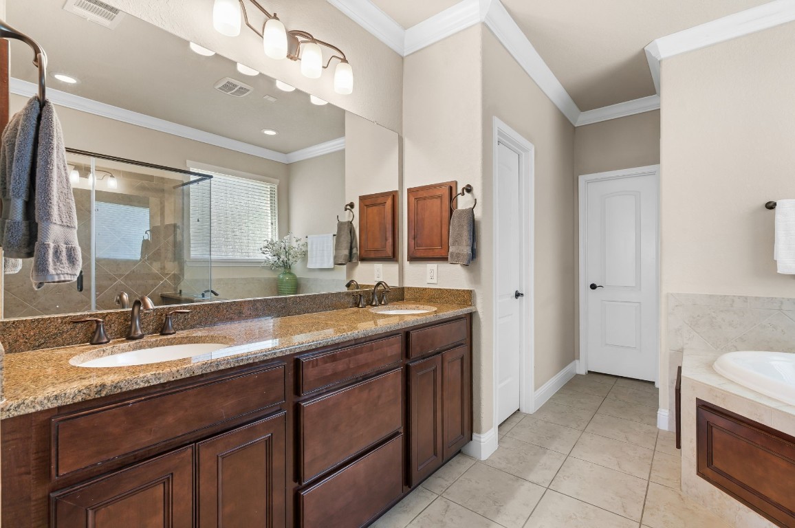 10 Waterfall Way The Woodlands, TX 77375 - Photo 24 of 45 a bathroom with a granite countertop sink double and mirror